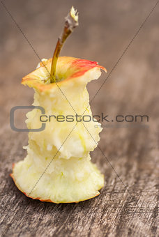 apple that has been eaten, on old wooden table