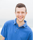 Smart young man smiling at the beach