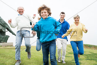 Happy family running at the lawn