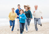 Happy family jogging atthe beach
