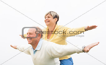 Happy man giving piggyback to woman