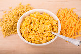 Dry Macaroni and Grated Cheese with Bowl of Mac n Cheese