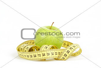 Green apple and measuring tape isolated on white background