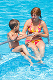 Mother with her son in the pool.