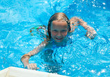 Girl in summer outdoor pool.