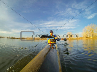 racing kayak against sunset