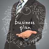 Man in suit holding business plan