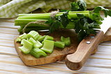 chopped green celery on a kitchen wooden board