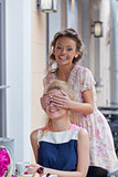 two beautiful young girls in summer outfit have lunch at the tab