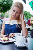 a beautiful young blond girl in summer dress at the table in pav