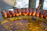 Baked sausages in traditional dish kotlovina