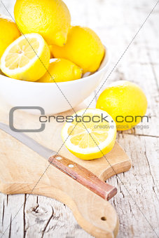 fresh lemons in a bowl and knife 