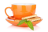 Cup of drink with crackers and mint