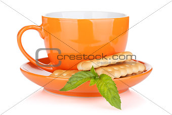 Cup of drink with crackers and mint