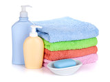 Cosmetics bottles, soap and colored towels