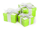 Three green gift boxes with silver ribbon and bow