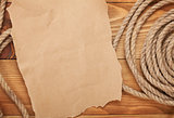 Old paper and rope on wooden textured background