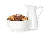 Various cookies in bowl and milk jug