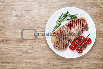 Sirloin steak with rosemary and cherry tomatoes on a plate