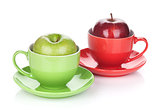 Ripe green and red apple in tea cup