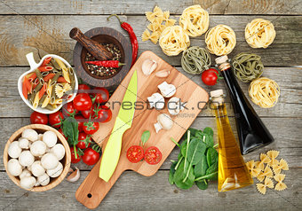 Fresh ingredients for cooking: pasta, tomato, mushroom and spice