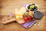 Red wine with cheese, olives and tomatoes