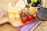 Red wine with cheese, olives, bread, vegetables and spices