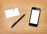 Business cards, pen and mobile phone