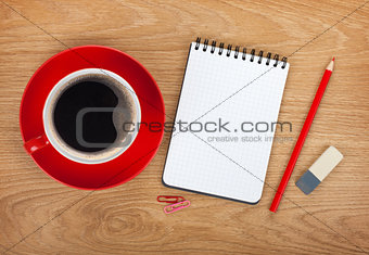 Blank notepad with office supplies and red coffee cup