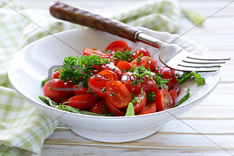 salad of small cherry tomatoes with parsley and olive oil