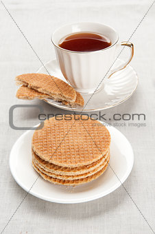 tea in a cup with biscuits