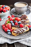 Chocolate eclairs with fresh berries