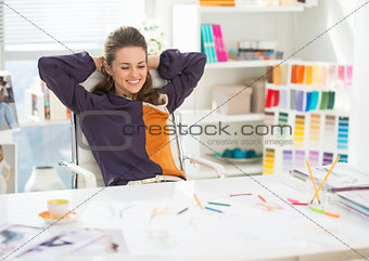 Portrait of relaxed fashion designer in office