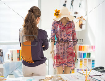 Fashion designer looking on garment