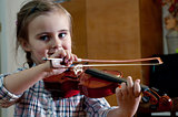 adorable little girl learning violin playing