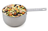 Mixed dried beans in a metal cup measure