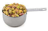 Shelled pistachio nuts in a metal cup measure
