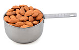 Whole unblanched almonds in a metal cup measure