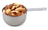 Whole brazil nuts in a metal cup measure