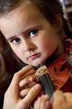 adorable little girl learning violin playing