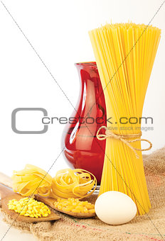 pasta and wooden spoon isolated on white background
