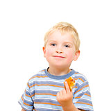 Cute little boy eating delicious cookie isolated on white