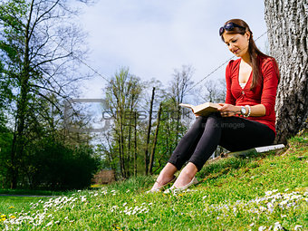 Woman reading outside in spring