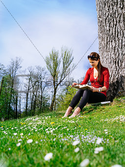 Young woman reading and enjoying spring