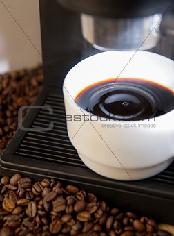 coffee maker machine with white coffee cup