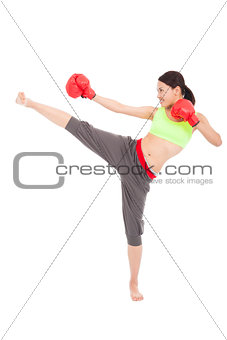 pretty sporty woman is kicking and punching