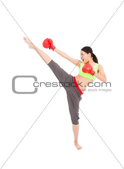 pretty female boxer  is kicking and punching