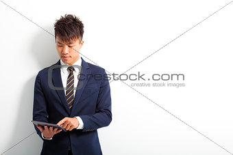 young male executive using digital tablet