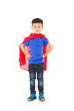 smiling Superhero kid standing over white background