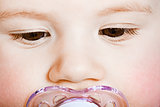face baby with pacifier closeup. macro